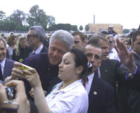The President stops near the Jardin de Tuileries to greet Parisians and pose for photographs.