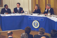 The President and First Lady sitting with panel members.