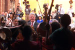 President Clinton smiles at a group of young musicians at the US Embassy event for the people of Joypura.
