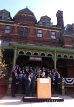 The First Lady, accompanied by state, city, local and community representatives, addresses the Pullman community outside the Hotel Florence.
