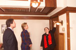 Karen Sweeney, Restoration Architect for the Robie House, displays some of Wright's innovative designs as the First Lady and Thomas Pritzker look on.